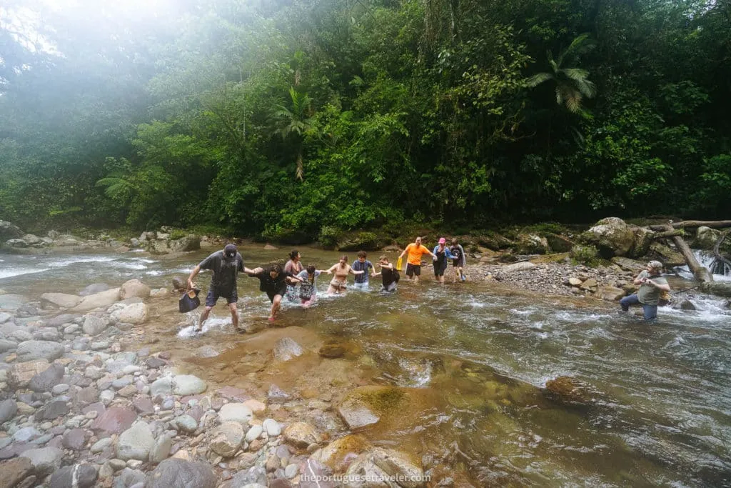 Crossing the river helped by our guide