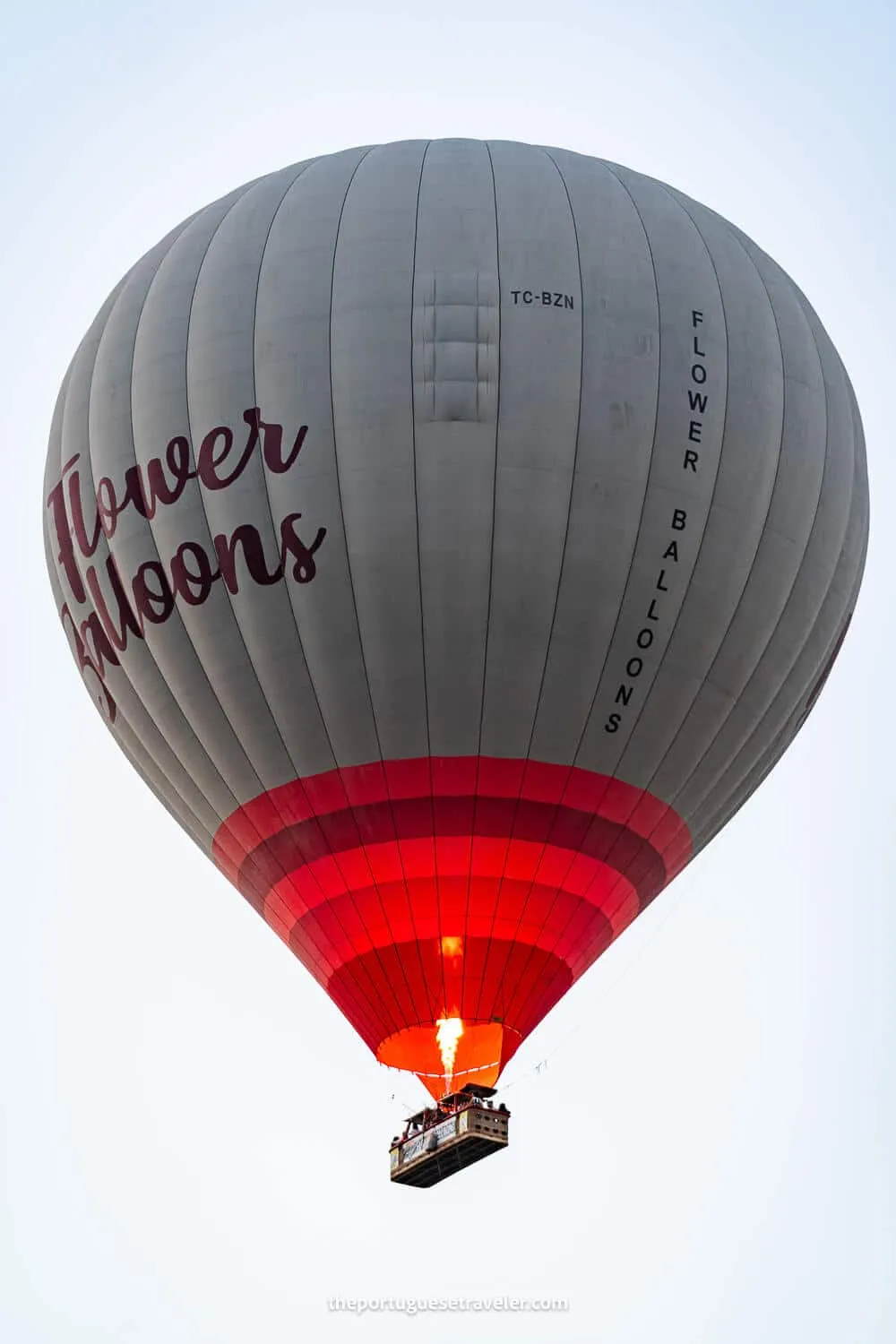 A hot air balloon flying in Cappadocia with a burst of fire