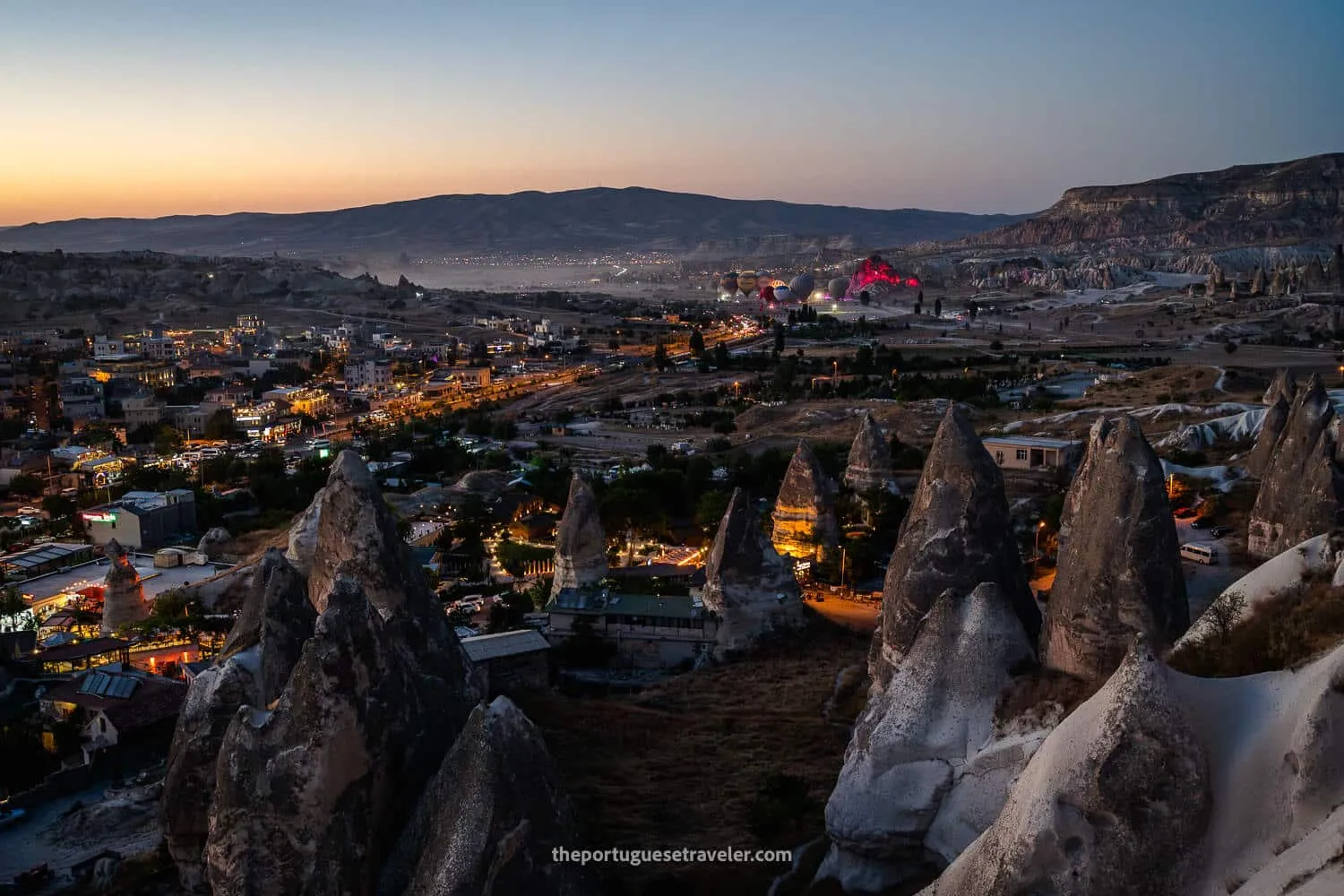 Göreme at dusk with a light show of hot air balloons
