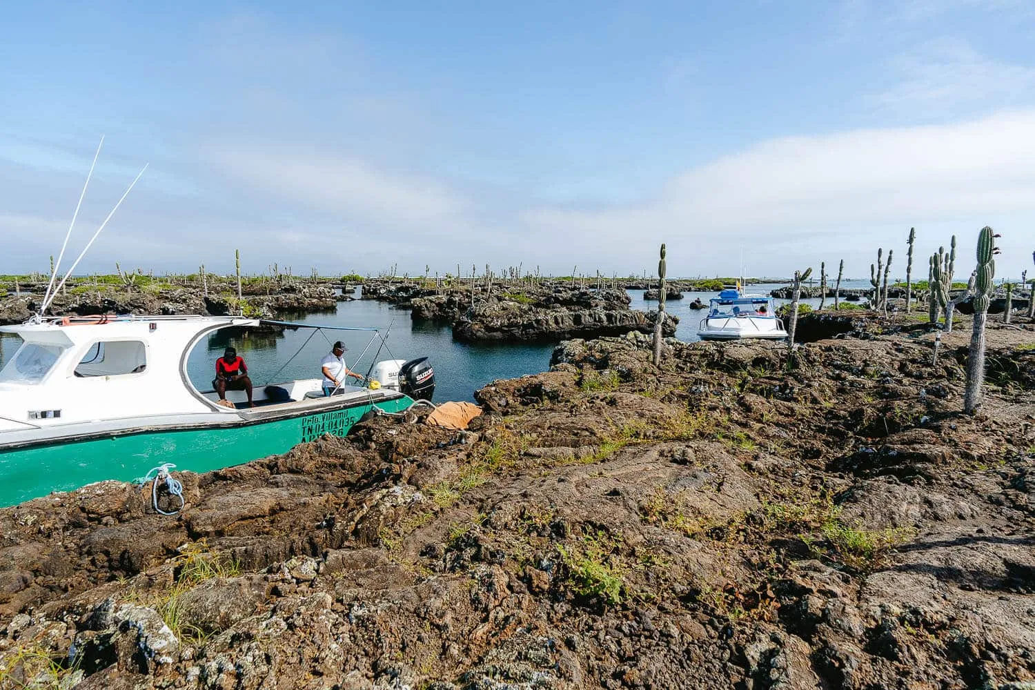 The boats parked next to the lava formations - Galapagos Islands Transportation Guide