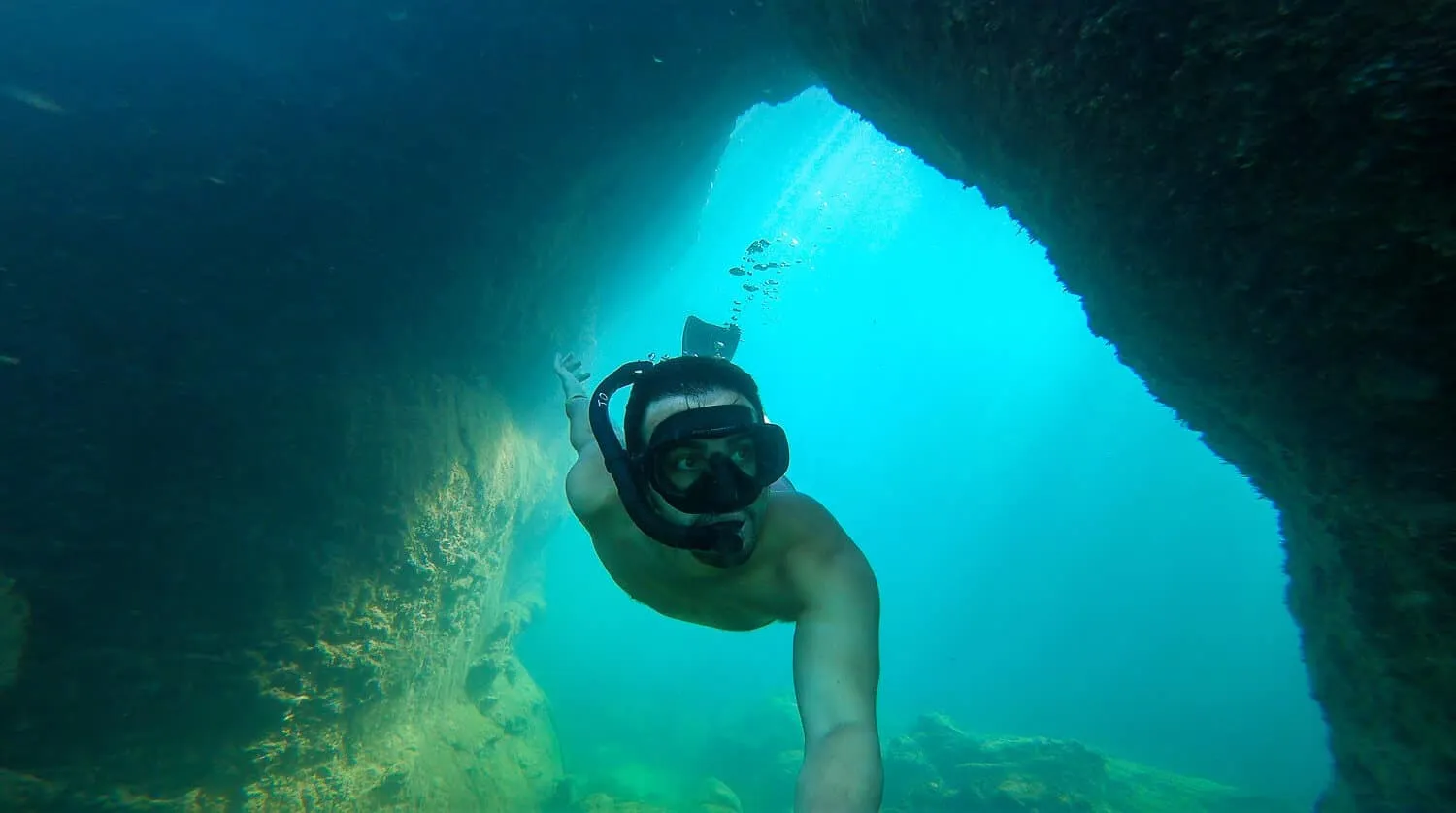 Me exploring the underwater passages in Los Túneles tour, Isabela - Galapagos Cruise vs Island Hopping