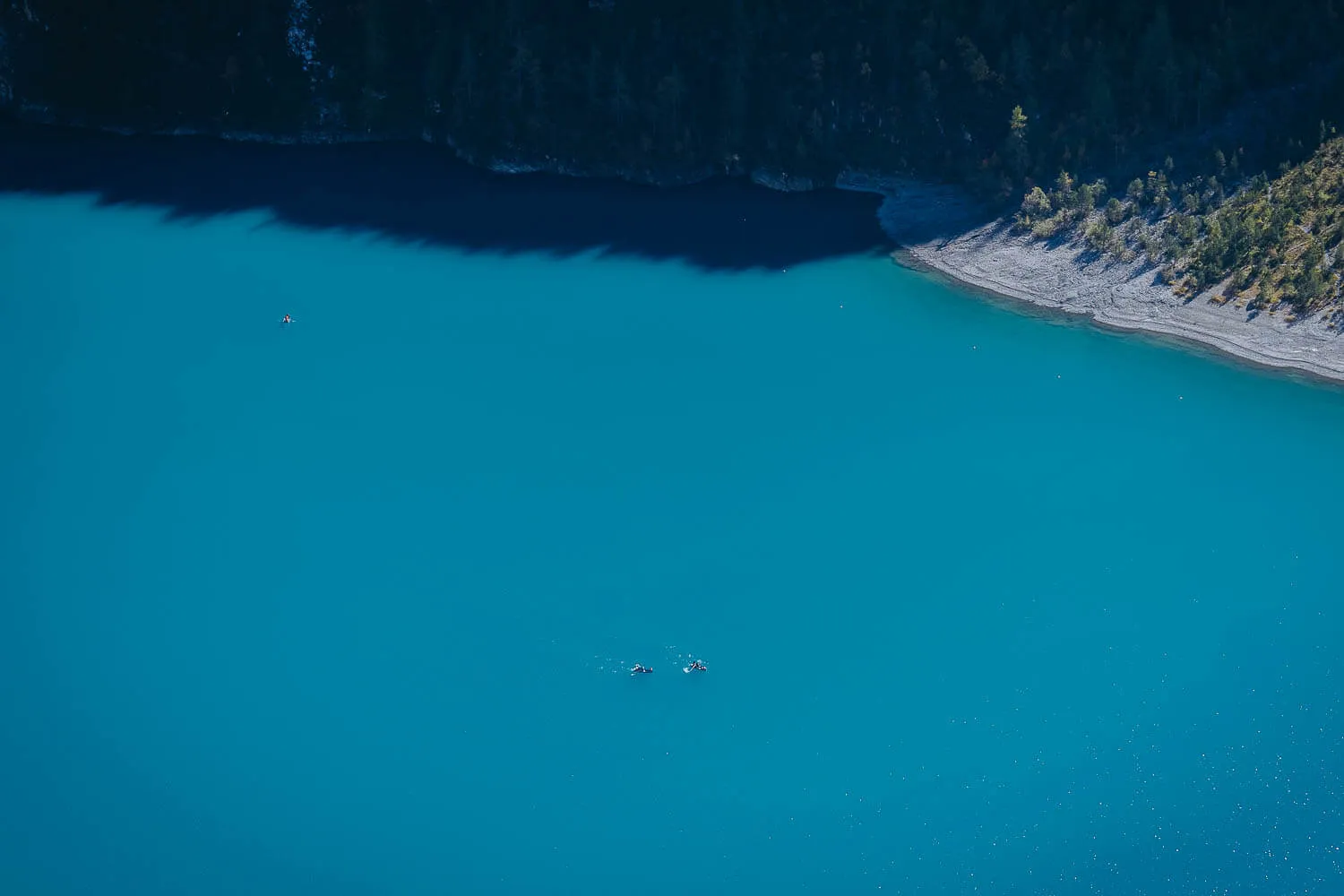 The boats and the beach of the Oeschinensee Lake